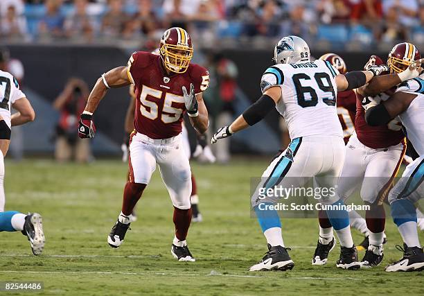 Jason Taylor of the Washington Redskins rushes the passer against Jordan Gross of the Carolina Panthers at Bank Of America Stadium on August 23, 2008...