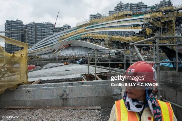 Worker looks on as the West Kowloon Terminus of the Guangzhou-Shenzhen-Hong Kong Express Rail Link is seen under construction in Hong Kong on August...