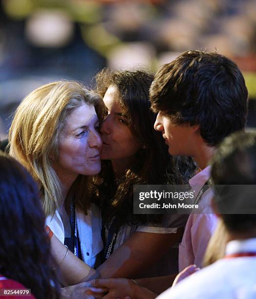 Caroline Kennedy Schlossberg kisses daughter Tatiana Schlossberg as he son Jack Schlossberg looks on at the podium before the first session of day...