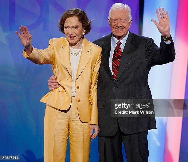 Former U.S. President Jimmy Carter and former first lady Rosalynn Carter wave on stage during day one of the Democratic National Convention at the...