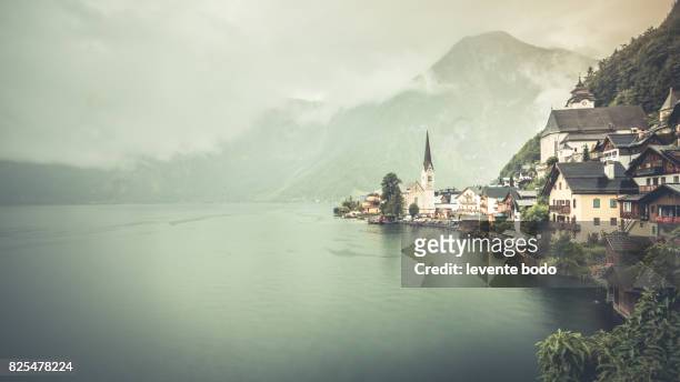 scenic picture-postcard view of famous hallstatt lakeside town in the austrian alps in beautiful morning light at sunrise on a sunny day in summer, salzkammergut region, austria - gmunden austria stock pictures, royalty-free photos & images