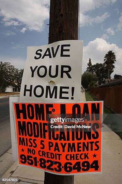 An advertisement for home loan modifications hangs on a suburban telephone pole on August 25, 2008 in Moreno Valley, California. Sales of existing...
