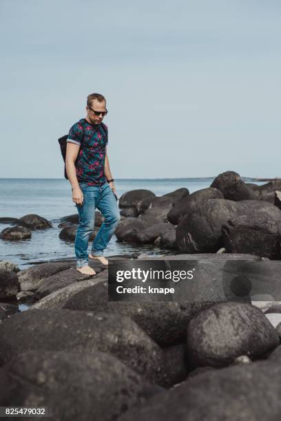 real man by the sea in summer - varberg stock pictures, royalty-free photos & images