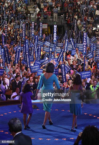 Michelle Obama , wife of presumptive Democratic nominee U.S. Sen. Barack Obama , walks on stage with her daughters Sasha and Malia during day one of...