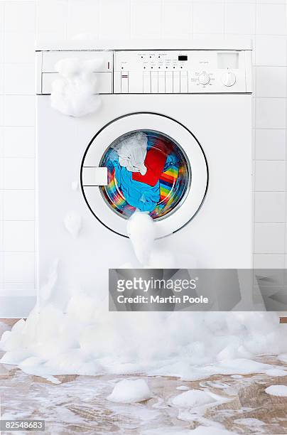 washing machine leaking , in laundry room - damaged stock-fotos und bilder