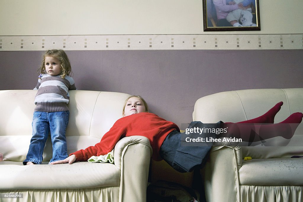 Two sisters relaxing at home