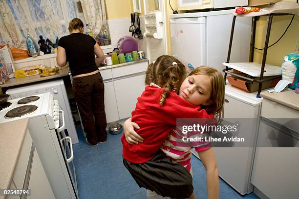 mother and sisters in the kitchen - arm around stock pictures, royalty-free photos & images