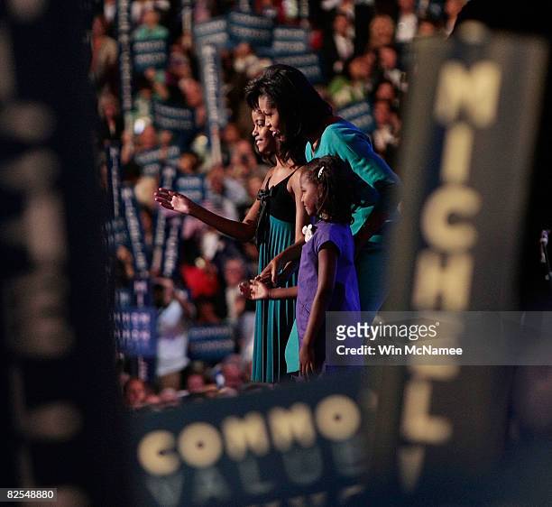Michelle Obama , wife of presumptive Democratic nominee U.S. Sen. Barack Obama , stands with her daughters Malia Sasha and on stage during day one of...