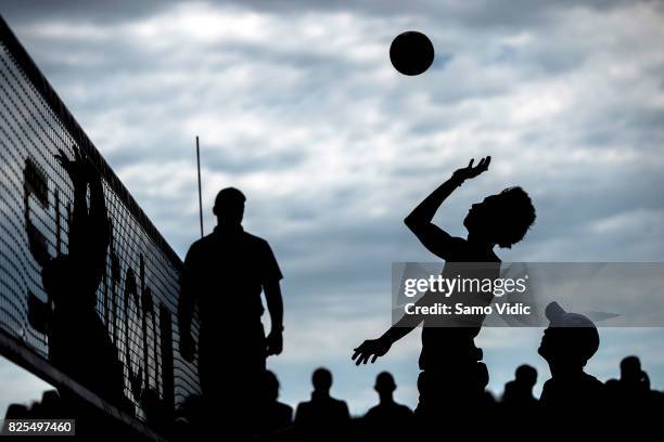 Nivaldo Nadir Diaz Gomez of Cuba spikes the ball during the match against Alvaro Magliano De Morais Filho and Saymon Barbosa Santos of Brazil at FIVB...