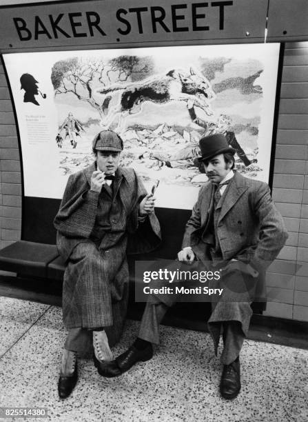 Actors Keith Mitchell and Denis Lill, as Sherlock Holmes and Doctor Watson respectively, posing on the new Jubilee Line platform at Baker Street...
