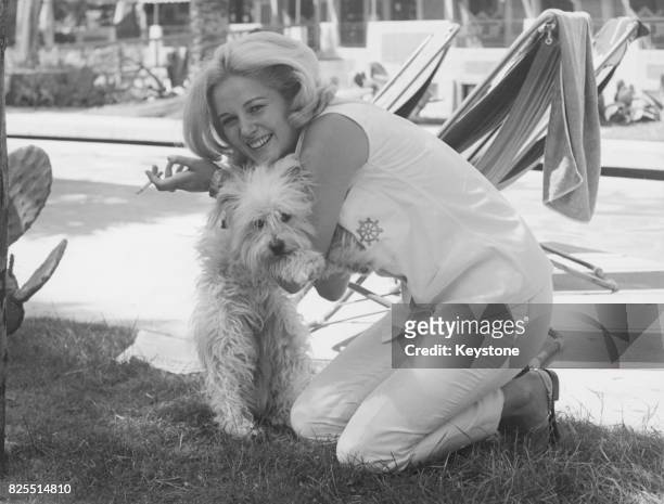 Serbian-Italian actress Beba Loncar with a dog in Rome, Italy, 21st June 1965.