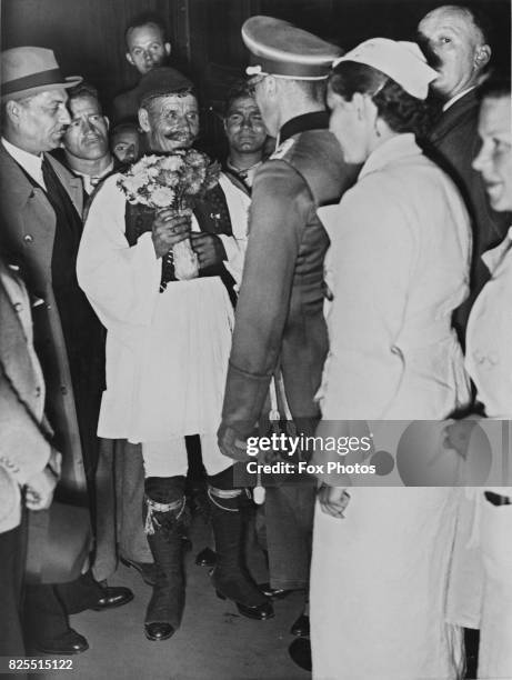 Greek runner Spyridon Louis is greeted upon his arrival in Berlin, Germany, for the Olympic Games, 31st July 1936. The winner of the 1896 Olympic...