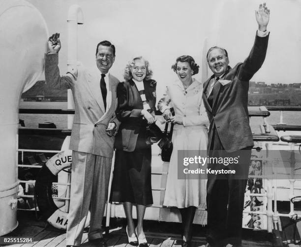 American actor and comedian Phil Harris and his wife, actress Alice Faye with actor Jack Benny and his wife, actress Mary Livingstone, on board the...