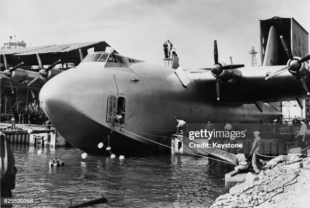 American aviator Howard Hughes atop his flying boat the Spruce Goose , directing operations for the launch at Long Beach, 6th November 1947. Here the...