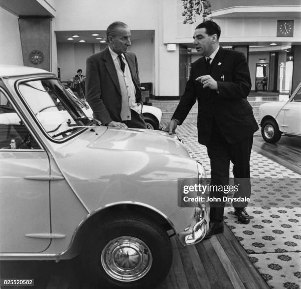 British-Greek car designer Alec Issigonis , Technical Director of BMC , talking to John Cooper about the Mini Cooper at Longbridge, Birmingham,...