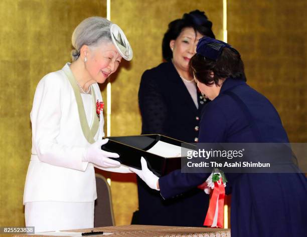 Empress Michiko presents the certificate to a laureate during the Florence Nightingale Medal Ceremony on August 2, 2017 in Tokyo, Japan.