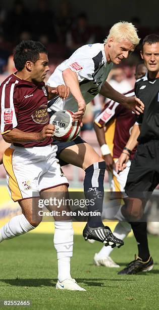 Zak Whitbread of Millwall attempts to clear the ball under pressure from Jason Crowe of Northampton Town during the Coca Cola League One Match...