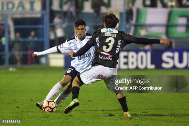 Luis Francisco Rodriguez of Bolivia's Oriente Petrolero vies for the ball with Tomas Cuello of Argentina's Atletico Tucuman during a Copa...