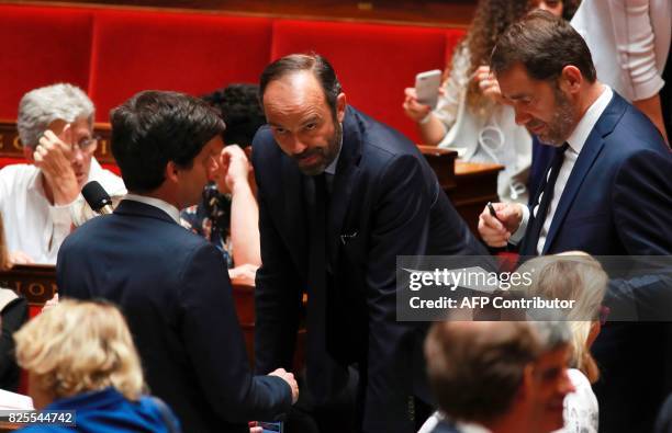Prime Minister Edouard Philippe flanked by Minister of State for Relations with Parliament and government spokesperson Christophe Castaner looks on...