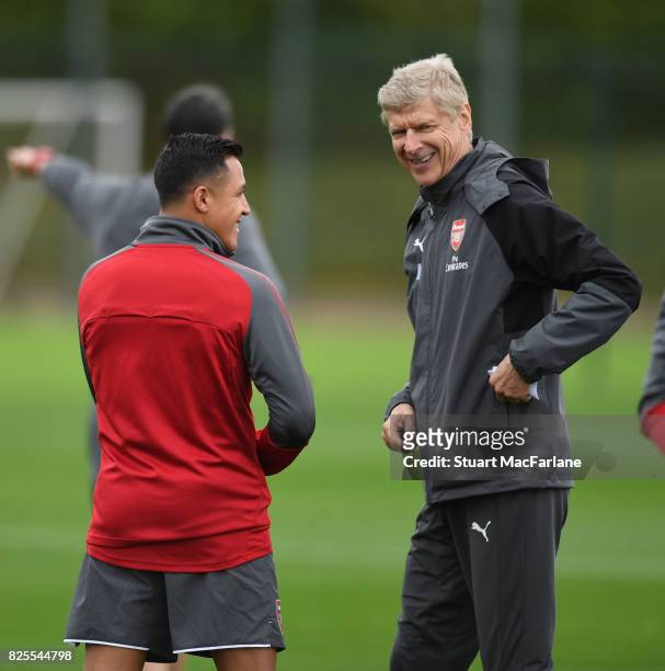 Arsenal manager Arsene Wenger shares a joke with Alexis Sanchez during a training session at London Colney on August 2, 2017 in St Albans, England.