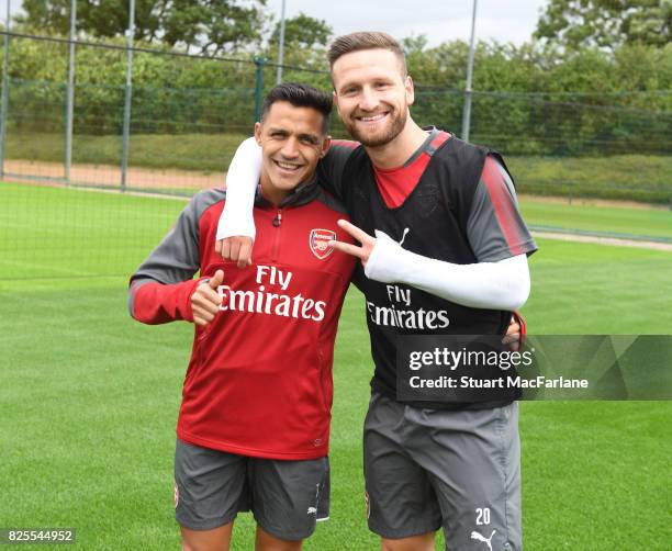 Alexis Sanchez and Shkodran Mustafi of Arsenal pose during a training session at London Colney on August 2, 2017 in St Albans, England.