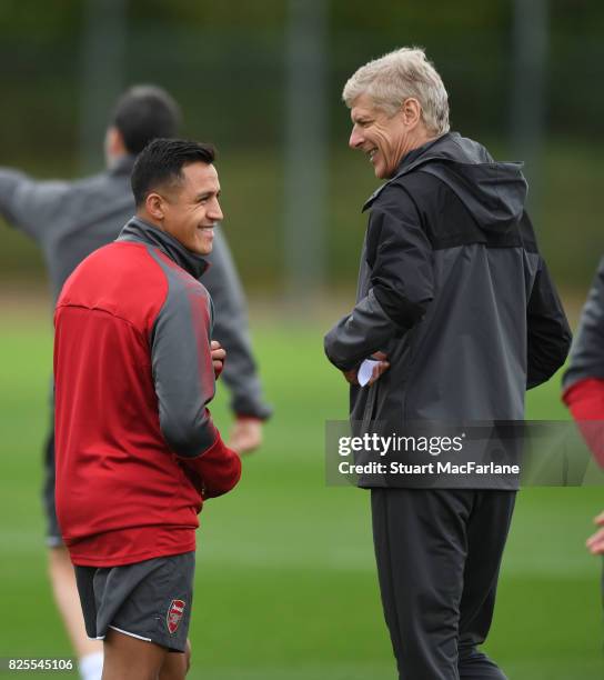 Arsenal manager Arsene Wenger shares a joke with Alexis Sanchez during a training session at London Colney on August 2, 2017 in St Albans, England.