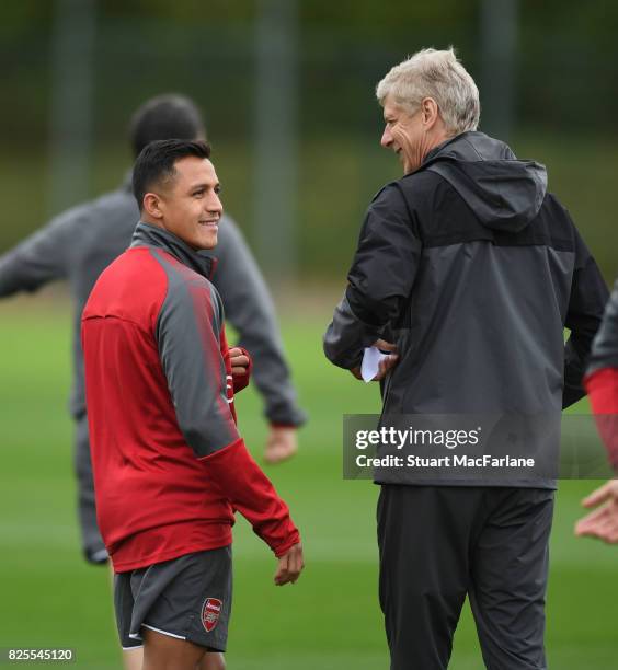 Arsenal manager Arsene Wenger shares a joke with Alexis Sanchez during a training session at London Colney on August 2, 2017 in St Albans, England.