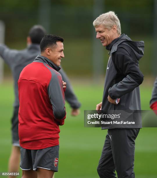 Arsenal manager Arsene Wenger shares a joke with Alexis Sanchez during a training session at London Colney on August 2, 2017 in St Albans, England.