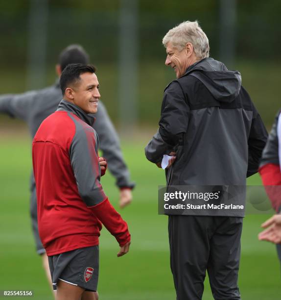 Arsenal manager Arsene Wenger shares a joke with Alexis Sanchez during a training session at London Colney on August 2, 2017 in St Albans, England.