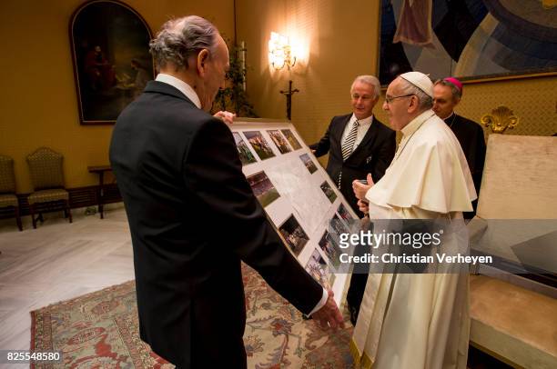 Pope Francis gets a present from President Rolf Koenigs and Vice President Rainer Bonhof during a private audience with his team of Borussia...