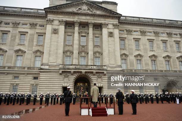 Onlookers watch as Britain's Prince Philip, Duke of Edinburgh, in his role as Captain General, Royal Marines, attends a Parade to mark the finale of...