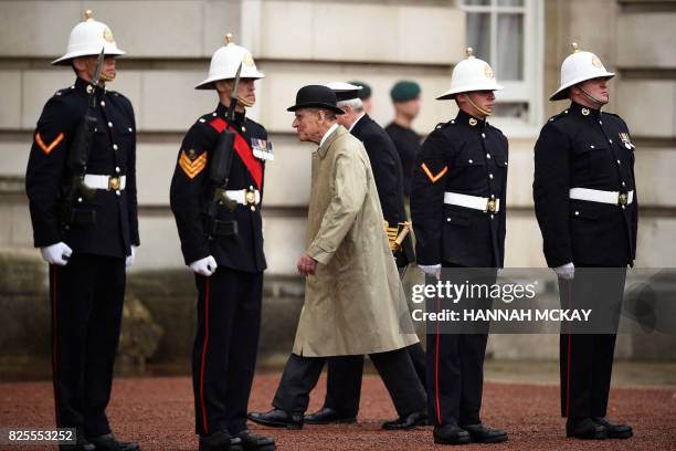 Onlookers watch as Britain's Prince Philip, Duke of Edinburgh, in his role as Captain General, Royal Marines, attends a Parade to mark the finale of...