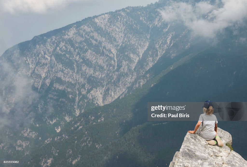 Boy  hiker looks off from high ridge crest, Mount Olympus, home of the gods of ancient Greece