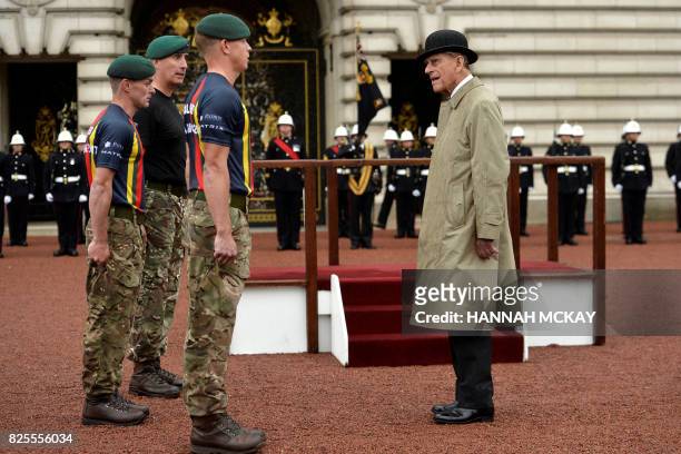 Onlookers watch as Britain's Prince Philip, Duke of Edinburgh, in his role as Captain General, Royal Marines, attends a Parade to mark the finale of...
