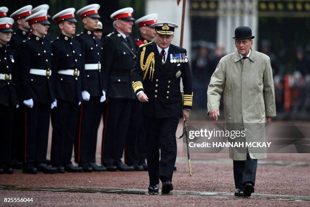 Onlookers watch as Britain's Prince Philip, Duke of Edinburgh, in his role as Captain General, Royal Marines, attends a Parade to mark the finale of...