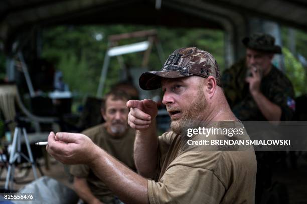 Members of the Georgia Security Force III% militia listen to founder Chris Hill give a briefing during a field training exercise July 29, 2017 in...
