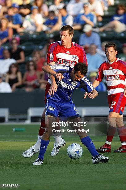 Kerry Zavagnin of the Kansas City Wizards protects the ball from Kenny Cooper of FC Dallas during the game at Community America Ballpark on August...
