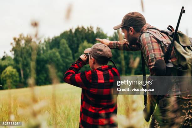 father and son hunting for boar - hunting rifle stock pictures, royalty-free photos & images