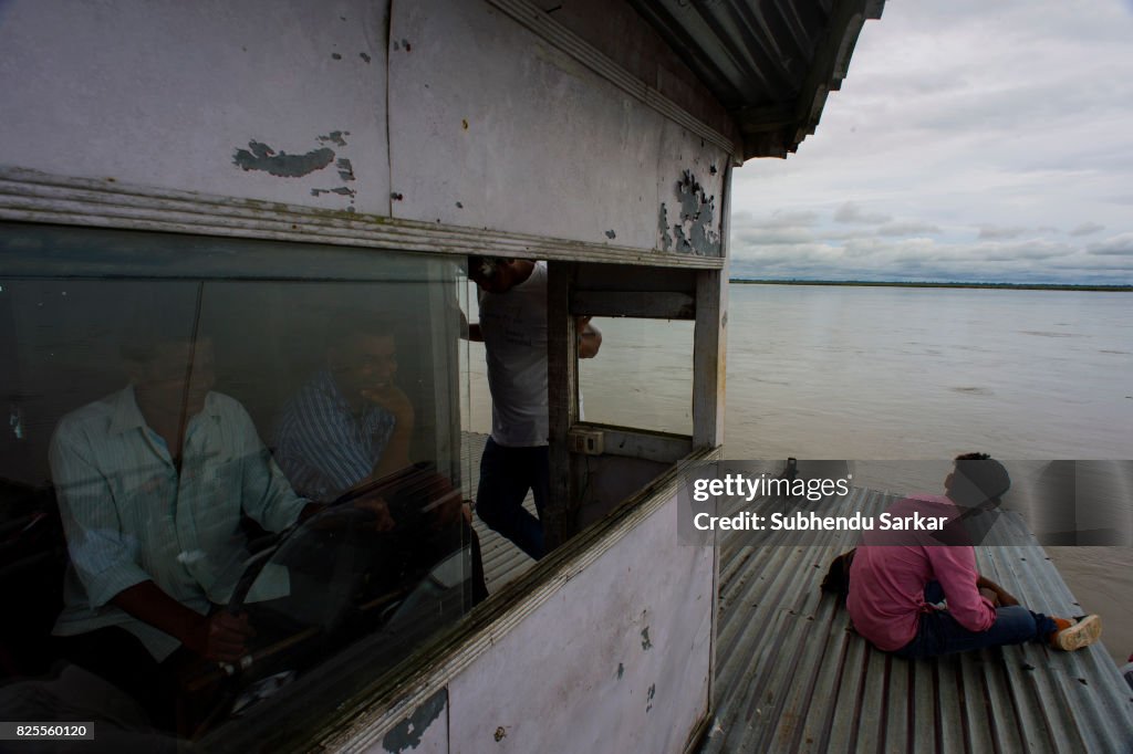 People cross the river Brahmaputra by ferry to reach Majuli...