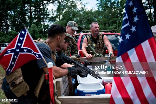Members of the Georgia Security Force III% militia wait together during a field training exercise July 29, 2017 in Jackson, Georgia. - Each month,...