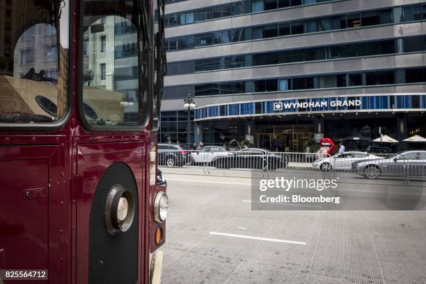 Tour bus stands in front of the Wyndham Grand Chicago Riverfront Hotel in downtown Chicago, Illinois, U.S., on Thursday, July 27, 2017. Wyndham...