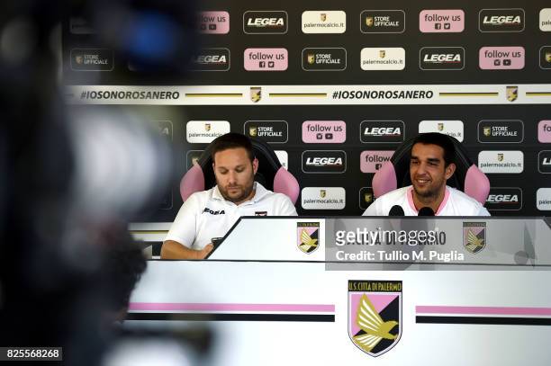 Andrea Siracusa, Head of Press Office, looks on as Giuseppe Bellusci answers questions during his presentation as new player of US Citta' di Palermo...