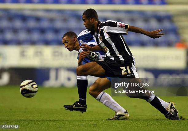 Spencer Weir-Daley of Notts County and Lewis Montrose of Wigan Athletic in action during the Carling Cup, second round match between Wigan Athletic...