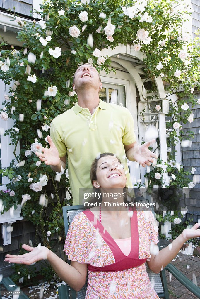 Carefree couple throwing flower petals