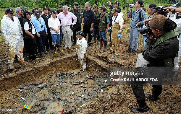 Colombian police officer takes pictures of a paramilitary mass grave with the presence of Prosecutor of the International Criminal Court Luis Moreno...