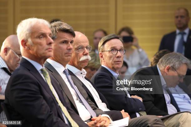 Dieter Zetsche, chief executive officer of Daimler AG, third left, listens while sitting beside Matthias Wissmann, president of the German Automotive...