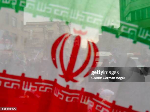 iran flag oblique and people behind - tehran - iran nuclear stock-fotos und bilder