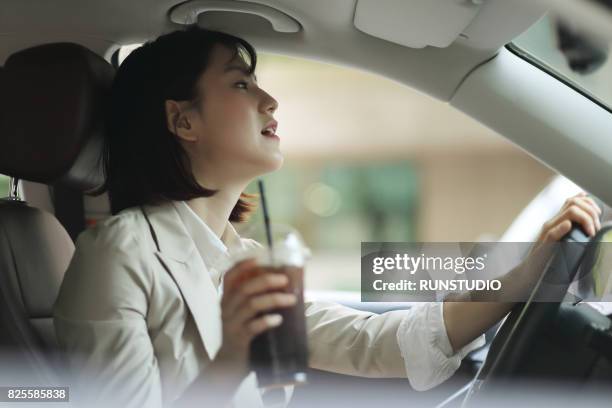 business woman driving with ice coffee - disposable cup stock pictures, royalty-free photos & images
