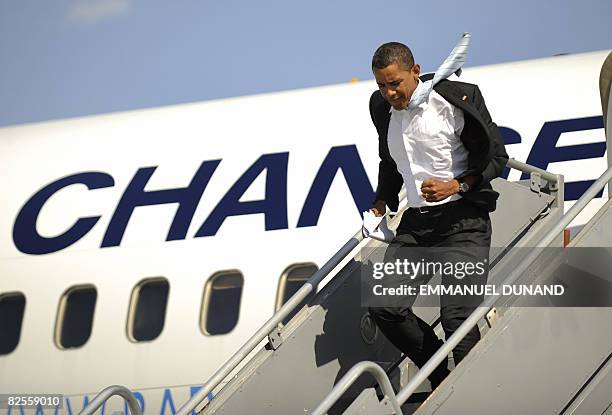 Democratic presidential candidate Illinois Senator Barack Obama disembarks facing strong winds from his campaign plane at Billings-Logan...