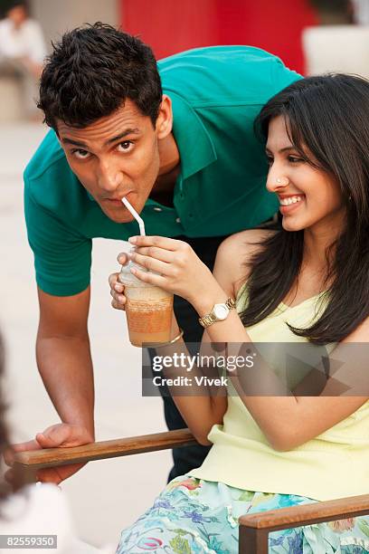 girlfriend sharing drink with boyfriend - bendy straw stock pictures, royalty-free photos & images